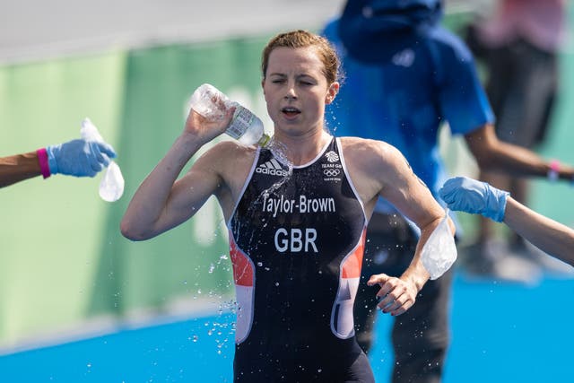 <p>Georgia Taylor-Brown pours water over herself in testing conditions at Odaiba Marine Park</p>