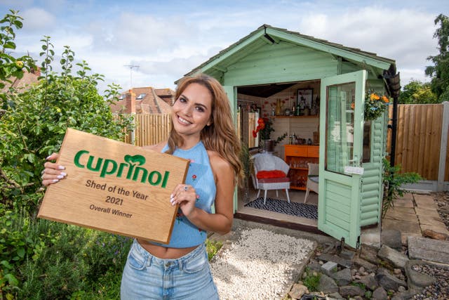 <p>Cuprinol Shed of the Year winner Danielle Zarb-Cousin with her 70s-inspired cocktail bar </p>
