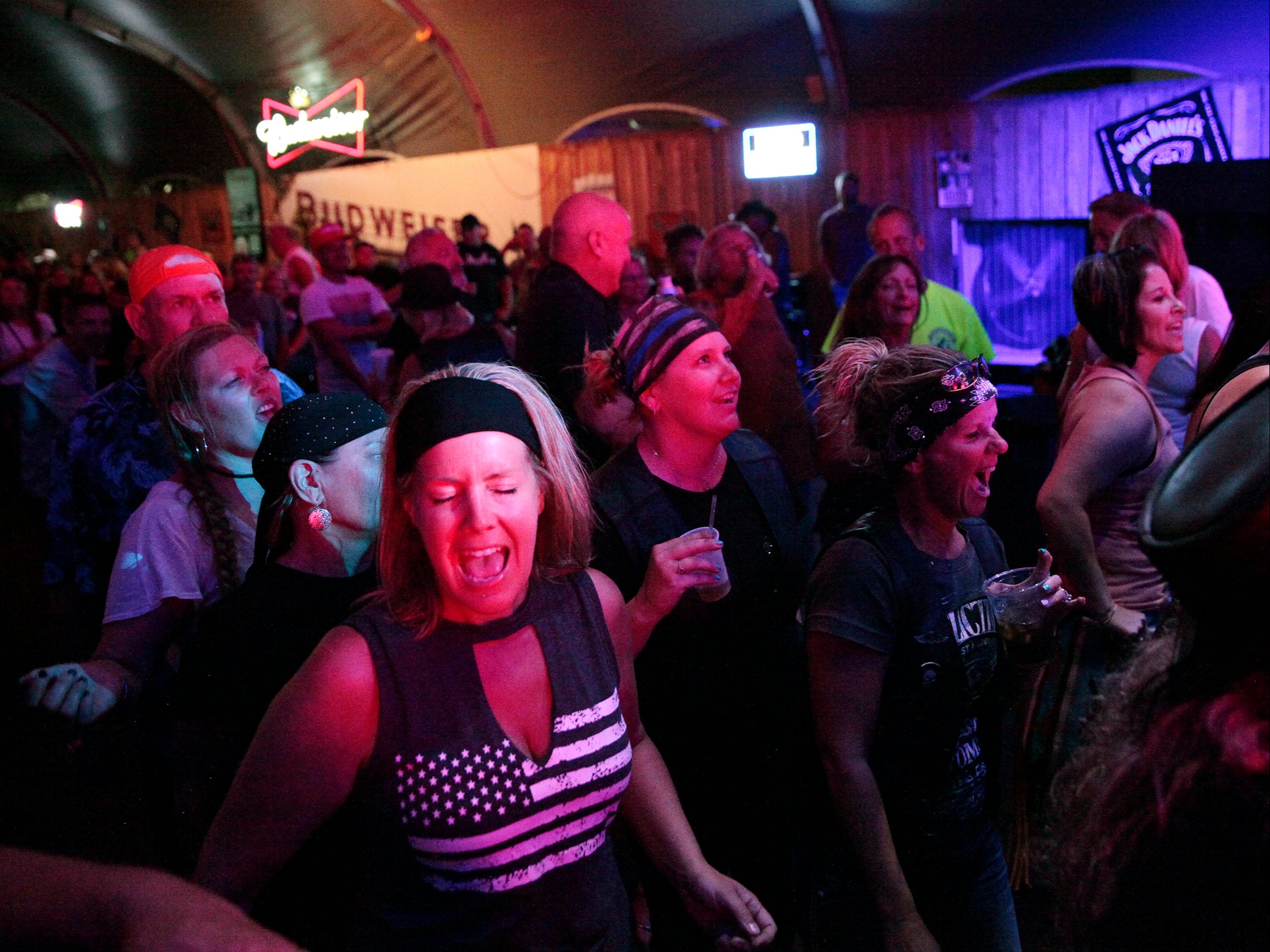 People sing and dance at a rock concert on Thursday, Aug. 5, 2021, in Sturgis, S.D. The Sturgis Motorcycle Rally starts Friday, even as coronavirus cases rise in South Dakota.