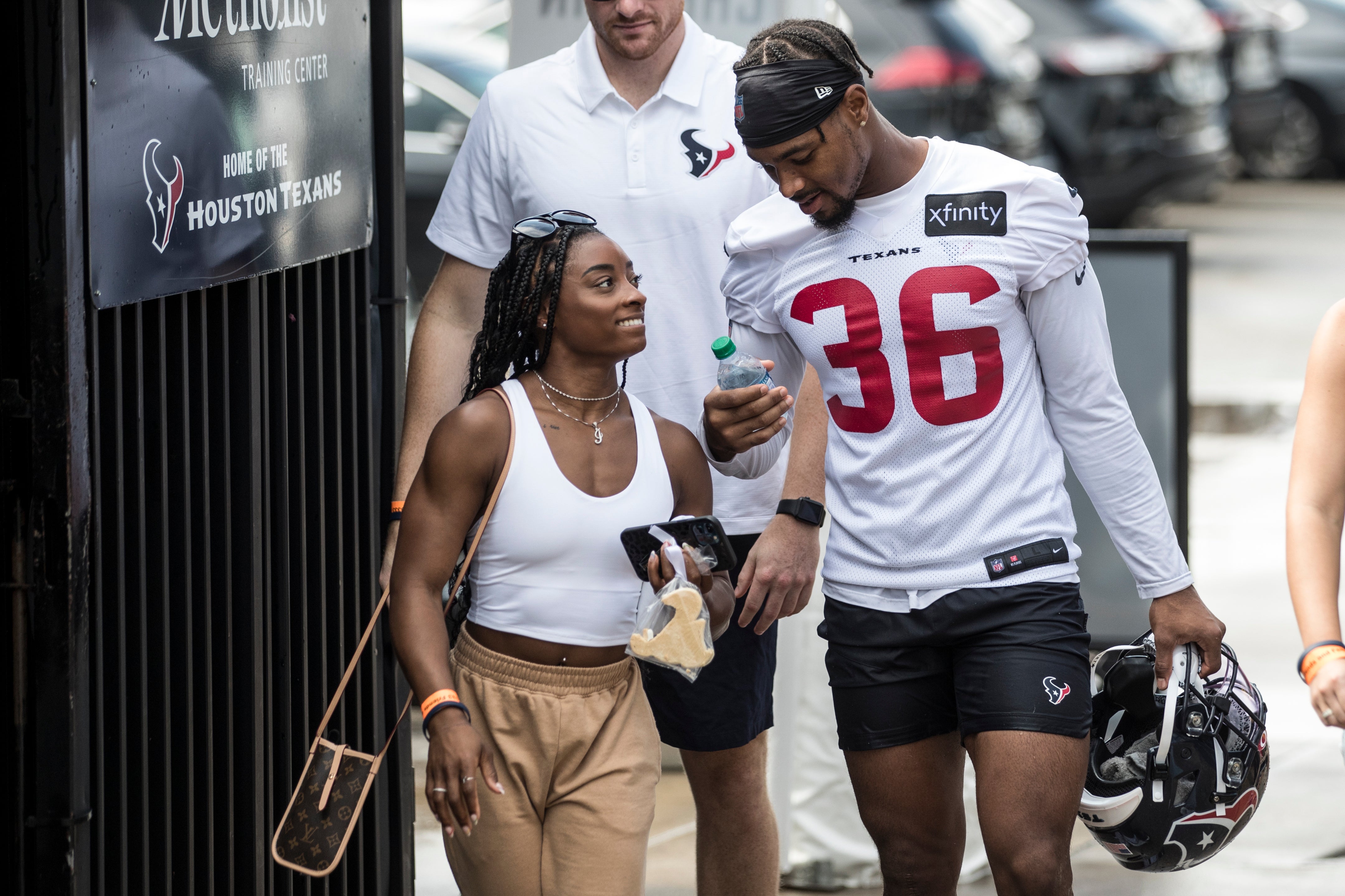 Olympic gymnast Simone Biles walks with her boyfriend Houston Texans defensive back Jonathan Owens (36) after the Texans’ practice at NFL football training camp, Friday, 6 August, 2021, in Houston.