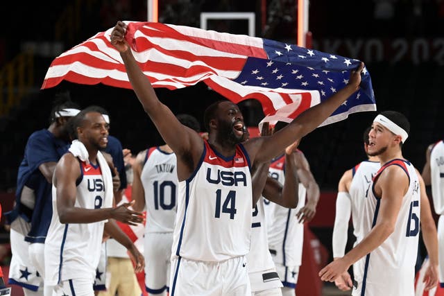 <p>USA's Draymond Jamal Green celebrates with the flag of the USA after their victory in the men's final basketball match between France and USA</p>