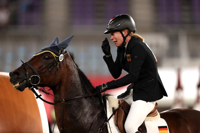<p>Annika Schleu of Germany cries after her horse Saint Boy refuses to budge in the show jumping at the Tokyo Olympics</p>