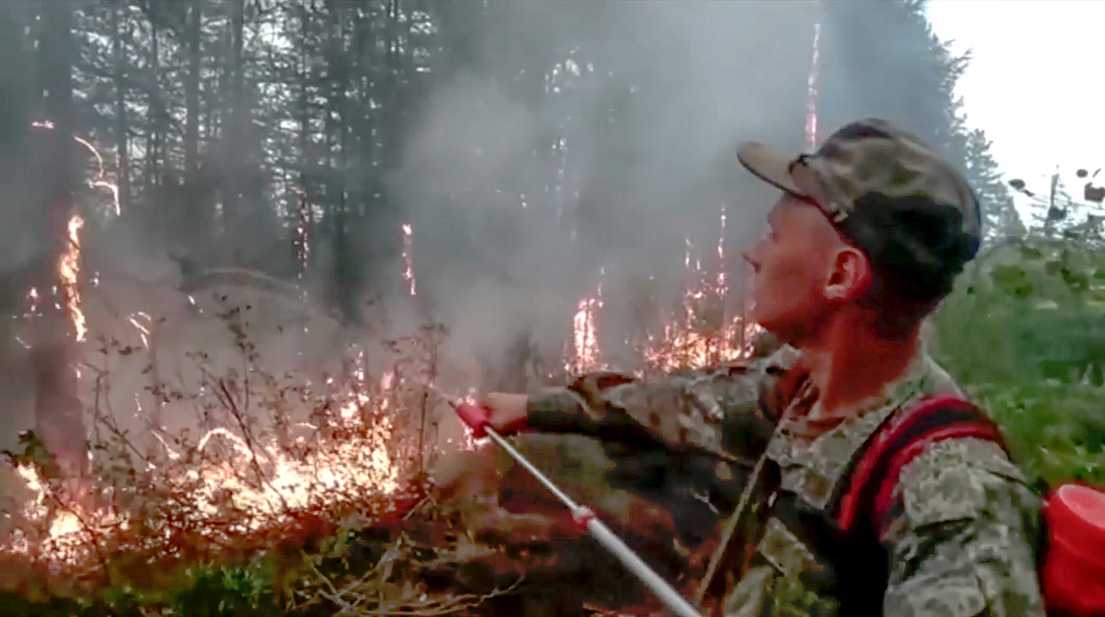 A Russian military engineer extinguishes forest fires in the Sakha Republic also known as Yakutia, far eastern Russia