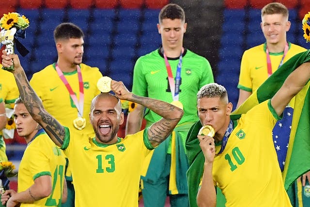 <p>Dani Alves (front left) and Richarlison (right) celebrate their victory</p>