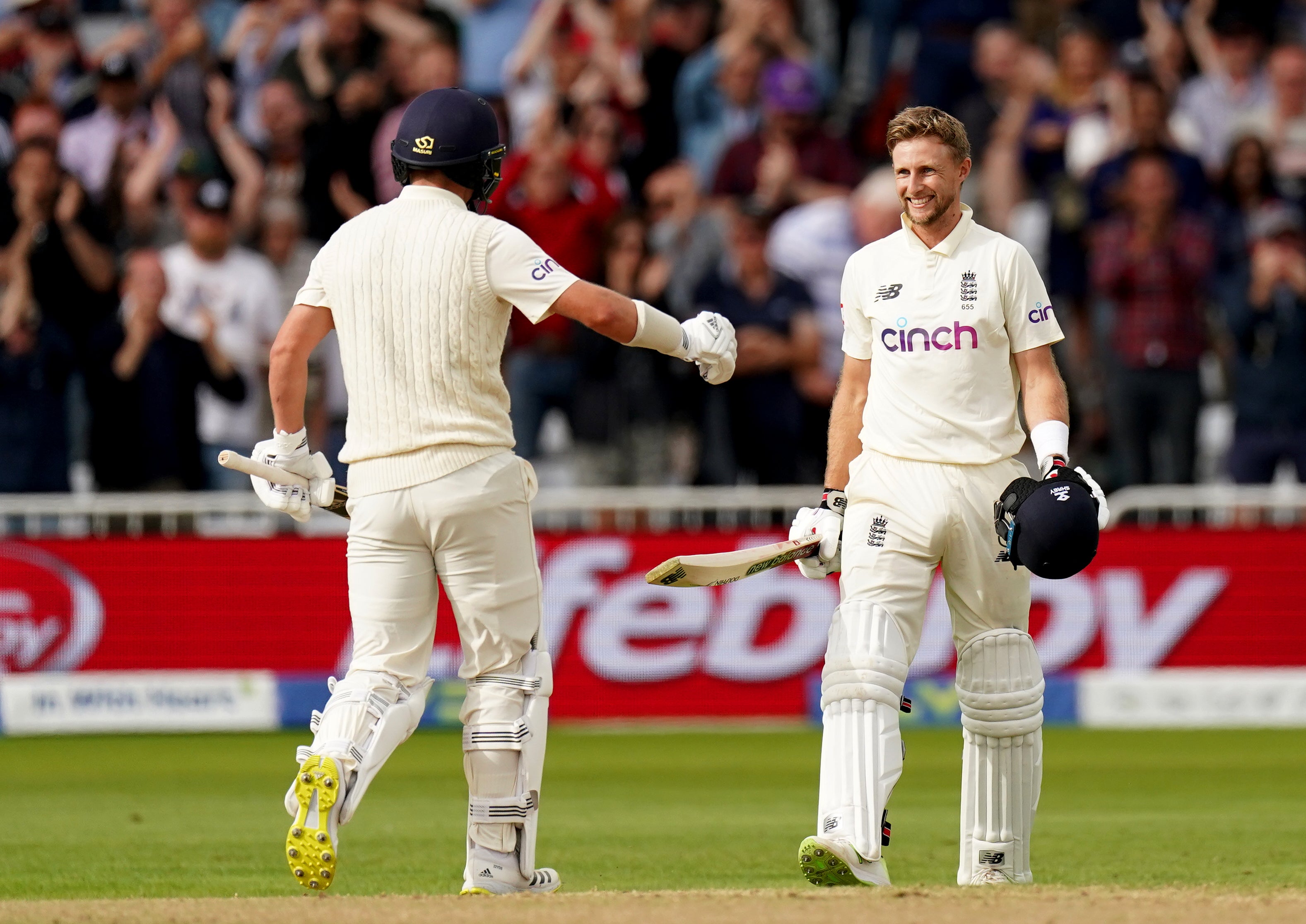 England’s Joe Root, right, celebrates his century with team-mate Sam Curran (Tim Goode/PA)