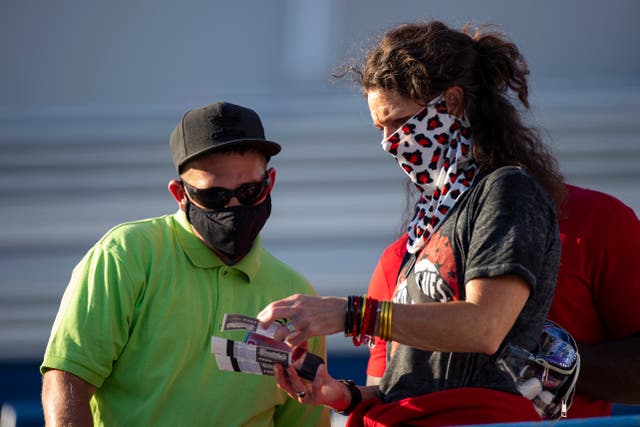 <p>A stadium worker (L) helps a fan find their seat as they both wear required face coverings before the game between the Memphis Tigers and the Arkansas State Red Wolves at Liberty Bowl Memorial Stadium on 5 September 2020 in Memphis, Tennessee.</p>