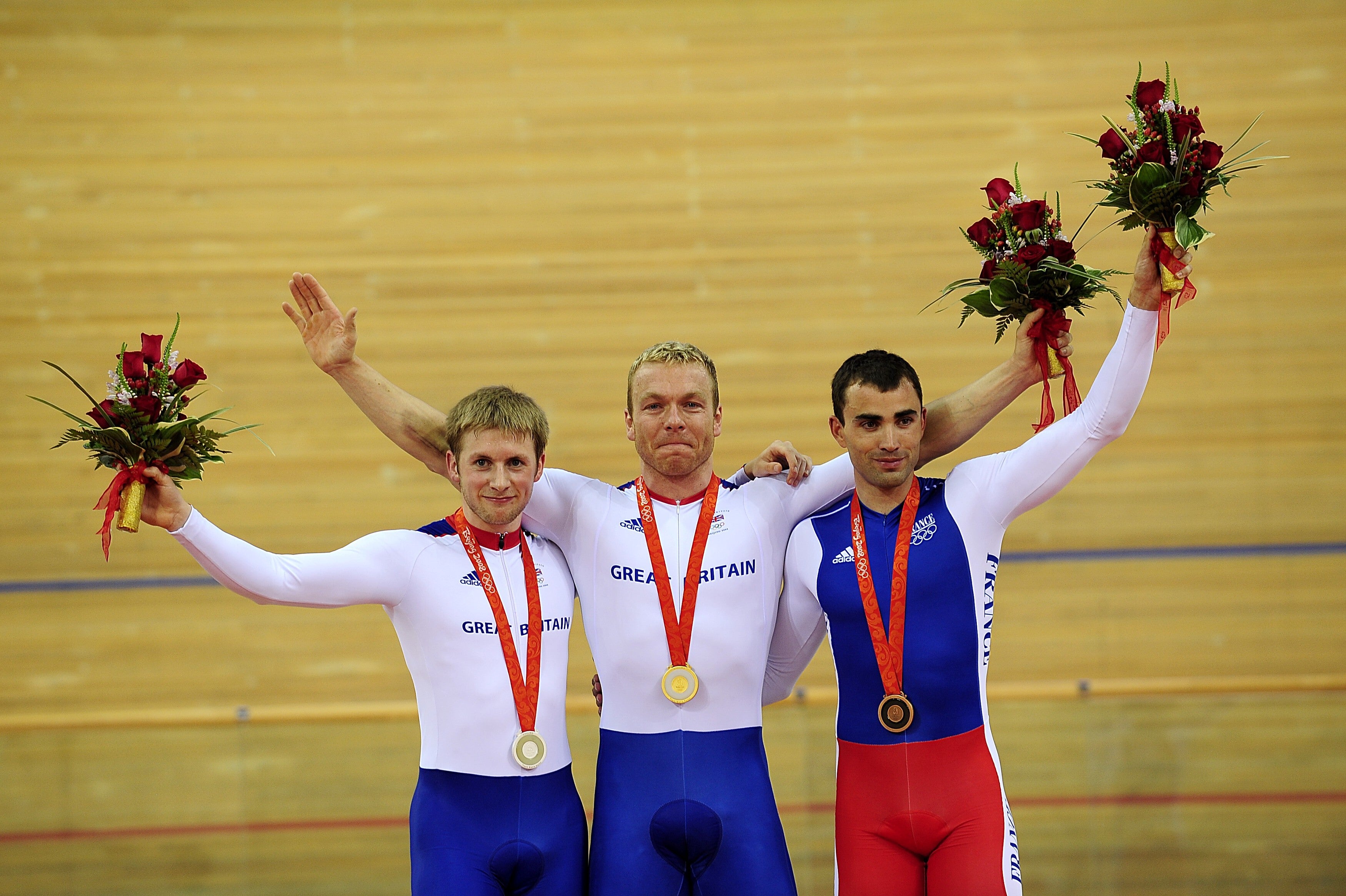 Kenny, left, celebrates gold on his Olympic debut alongside Hoy and Staff (John Giles/PA)