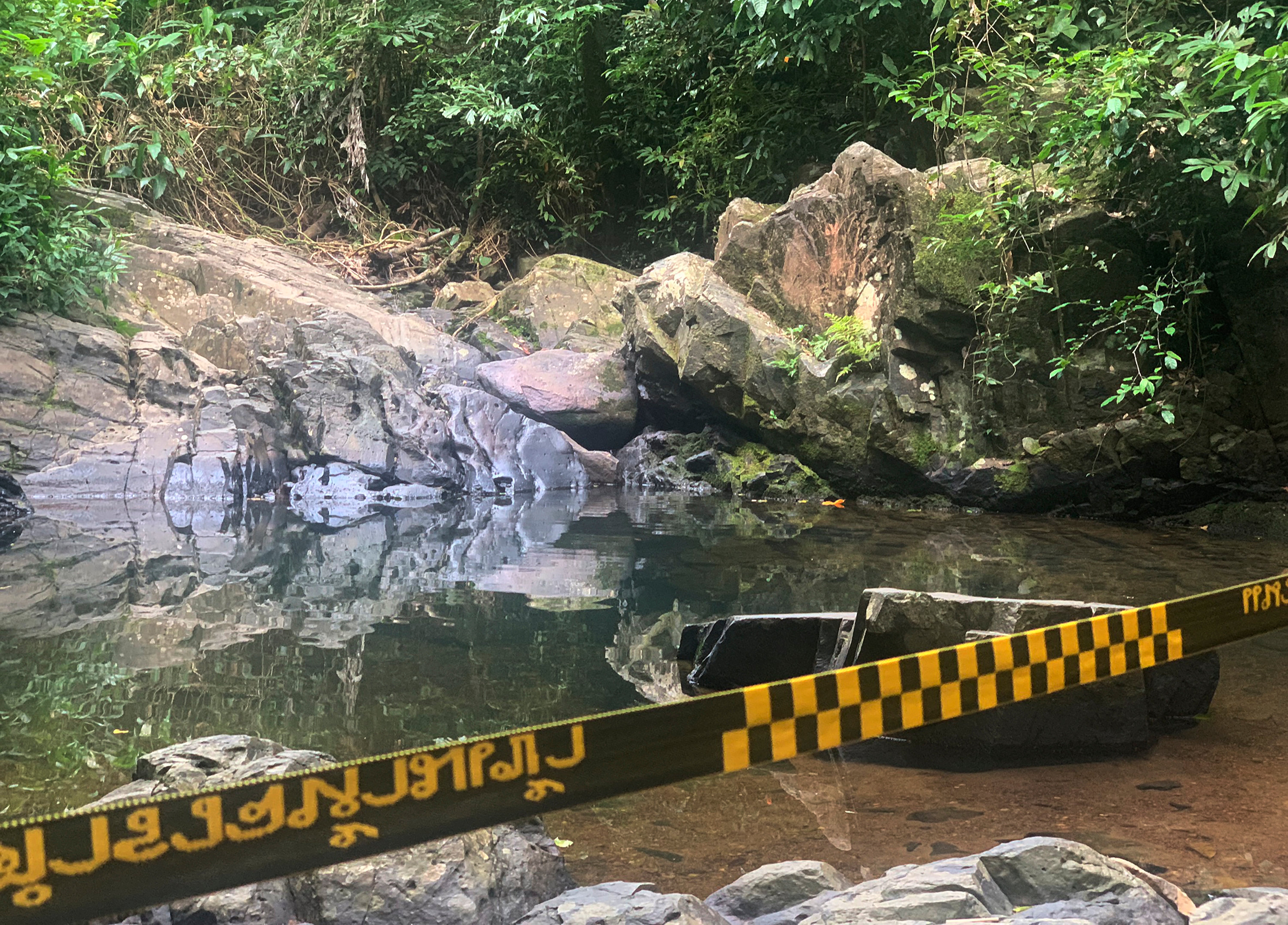 Police tape cordons off the area where a woman was found dead at a secluded spot in Phuket