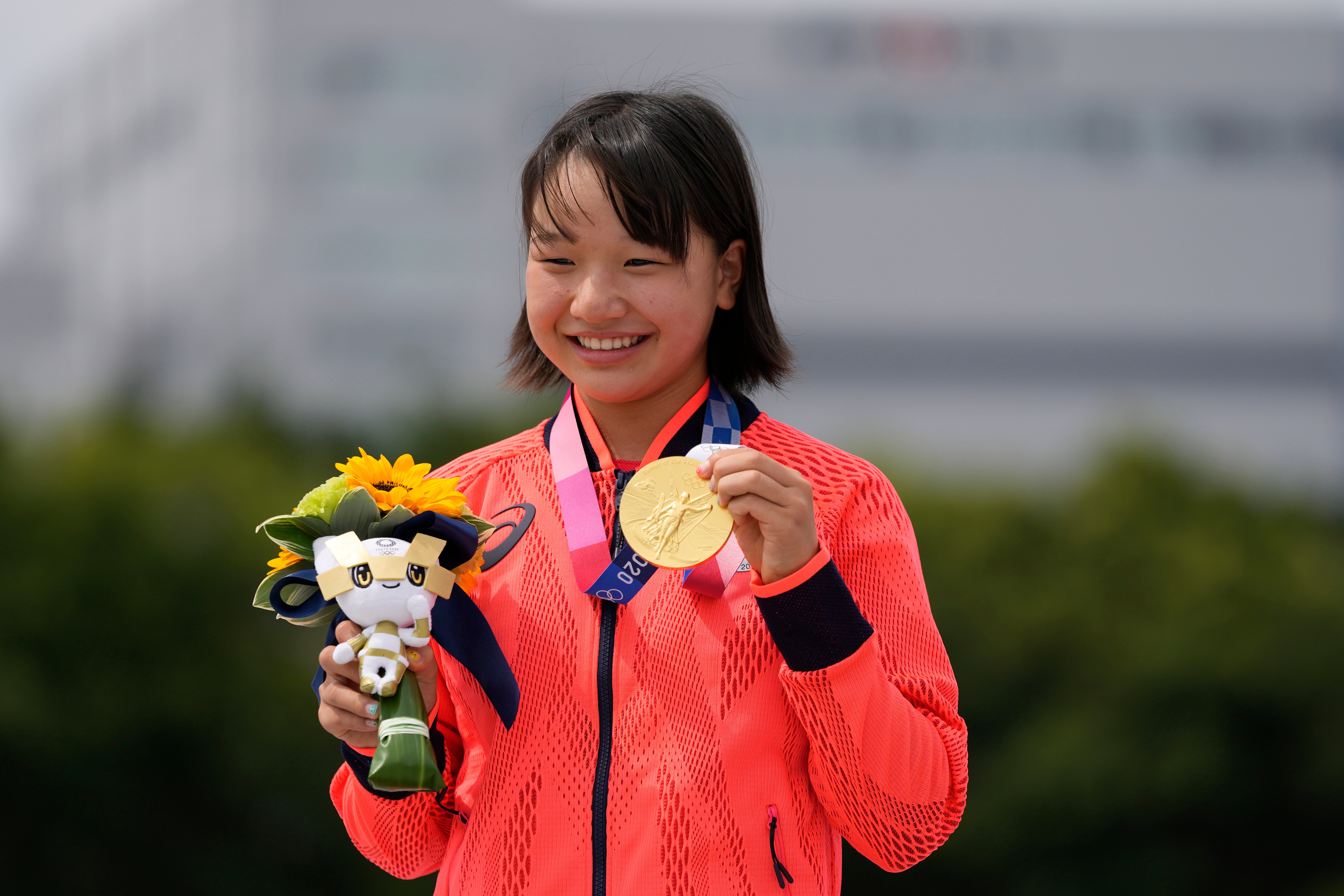 Momiji Nishiya holds her gold medal after winning the Women’s Street skateboarding