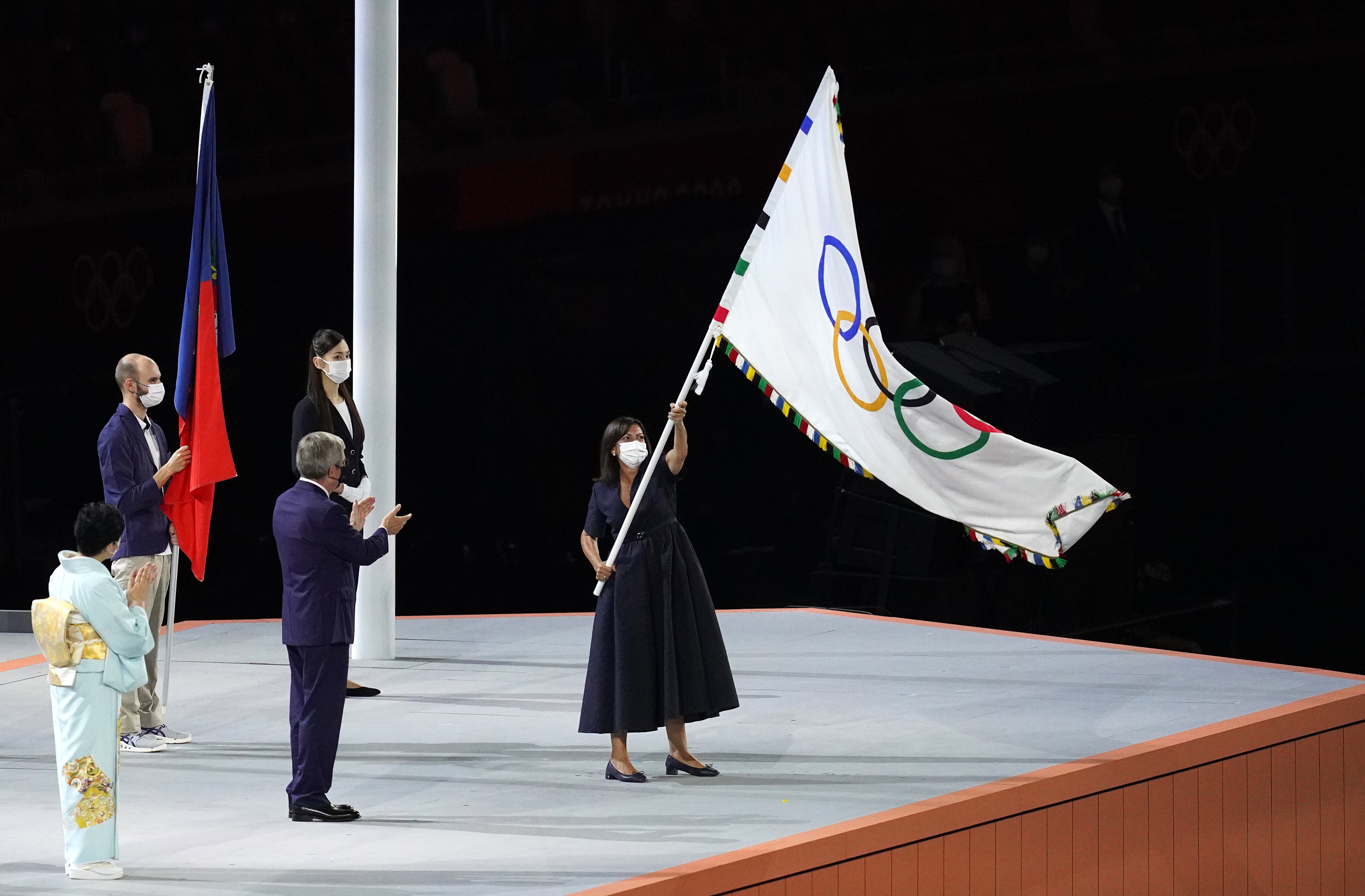 The Mayor of Paris, Anne Hidalgo, takes the Olympic flag (Martin Rickett/PA)