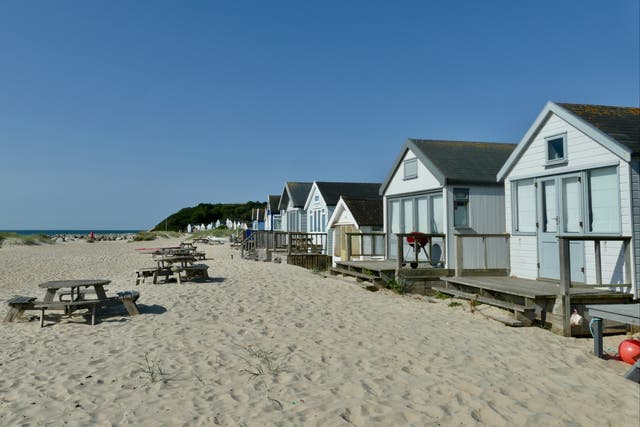 <p>Beach huts along the Mudeford sandbanks </p>