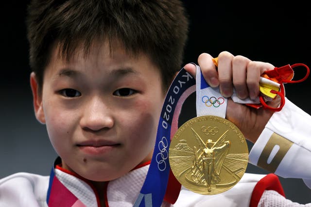 <p>Gold medalist Hongchan Quan of Team China celebrates during the medal ceremony for the Women’s 10m Platform Final</p>