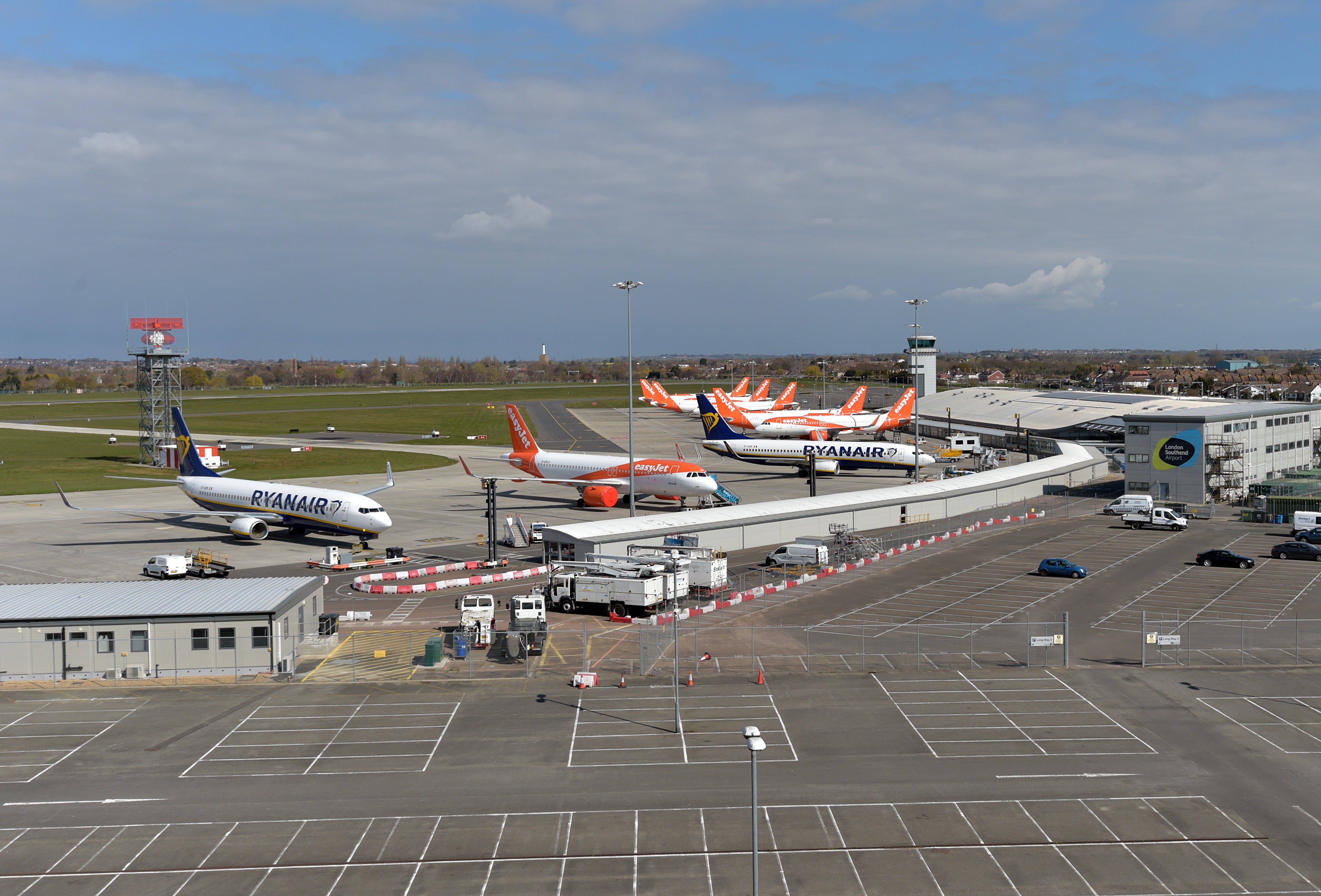 Ryanair and easyJet aircraft parked near an empty long stay car park at Southend airport