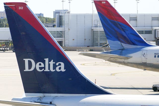<p>Tails of two Delta Air Lines jets are visible at their gates 17 September 2004</p>
