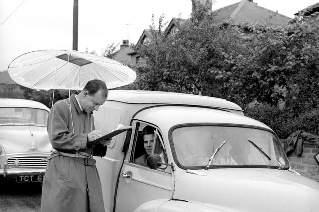 <p>A man collects census answers at a checkpoint in Dalton, Yorkshire, six decades ago</p>