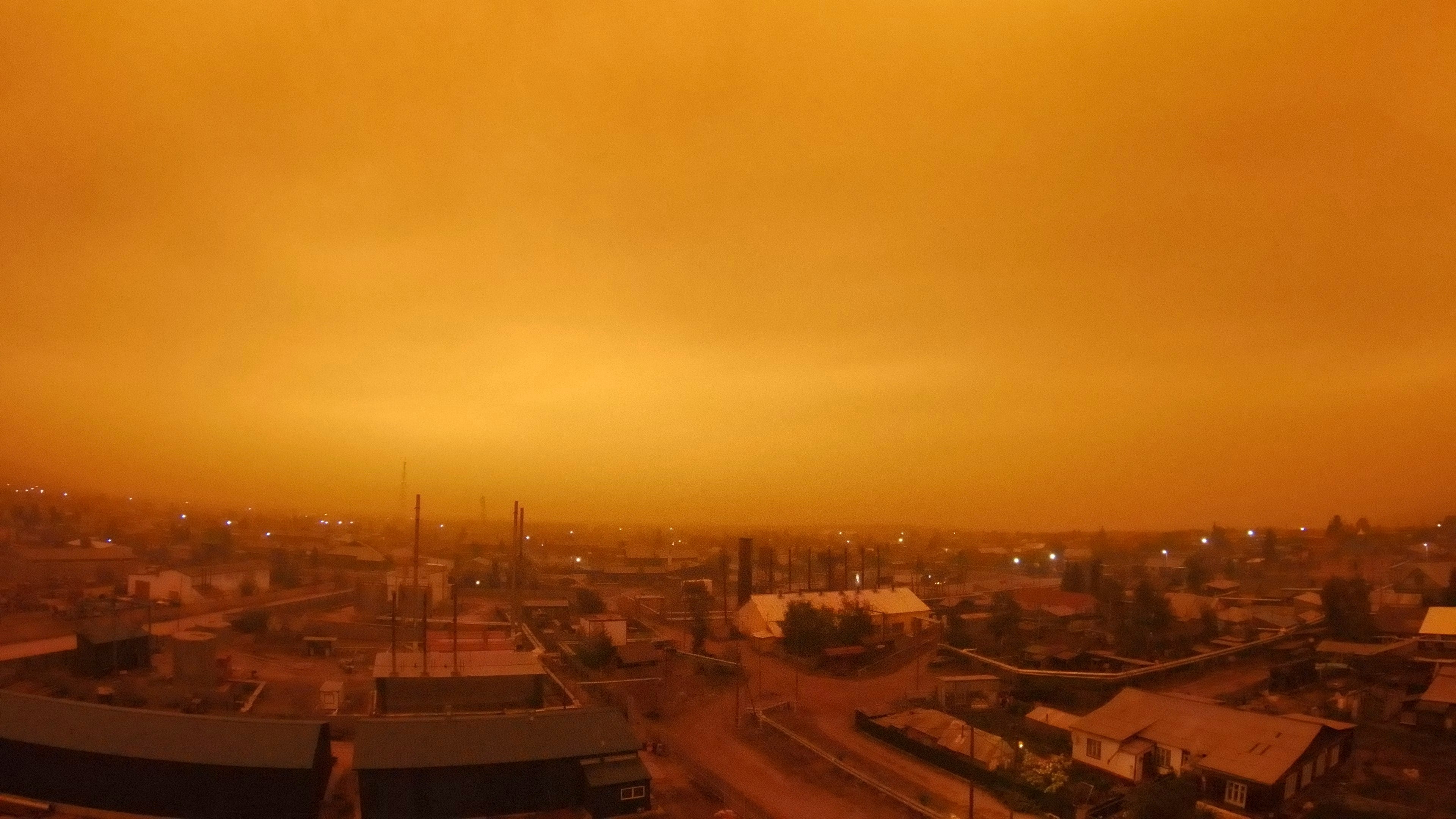 Smoke from forest fires is see over small town of Kysyl-Syr