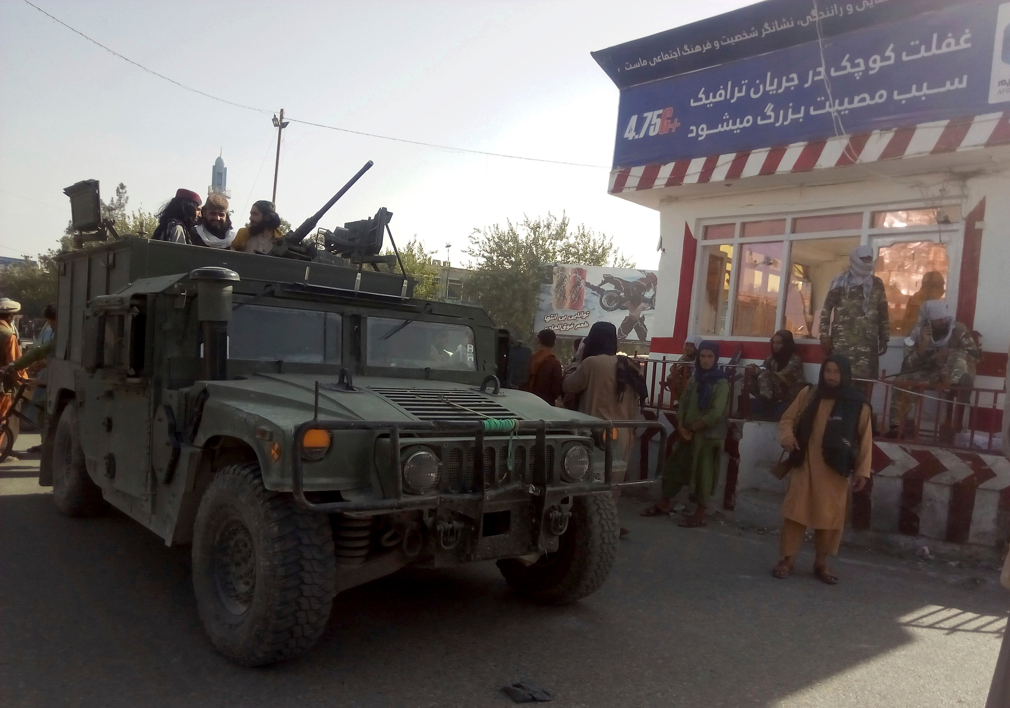 File: Taliban fighters stand guard at a checkpoint in Kunduz city, northern Afghanistan, August 9 2021