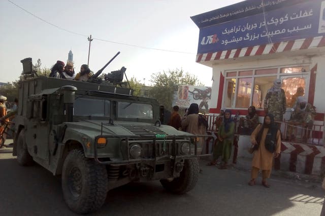 <p>File: Taliban fighters stand guard at a checkpoint in Kunduz city, northern Afghanistan, August 9 2021</p>