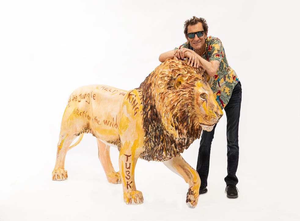 Ronnie Wood with his Tusk lion sculpture (Tusk/PA)