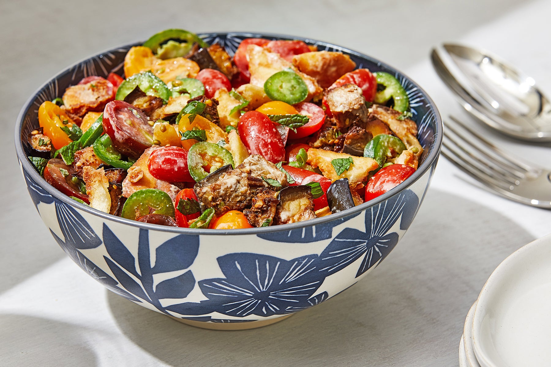 This one takes the traditional Palestinian tomato-tahini salad and marries it with fried aubergine sandwiches