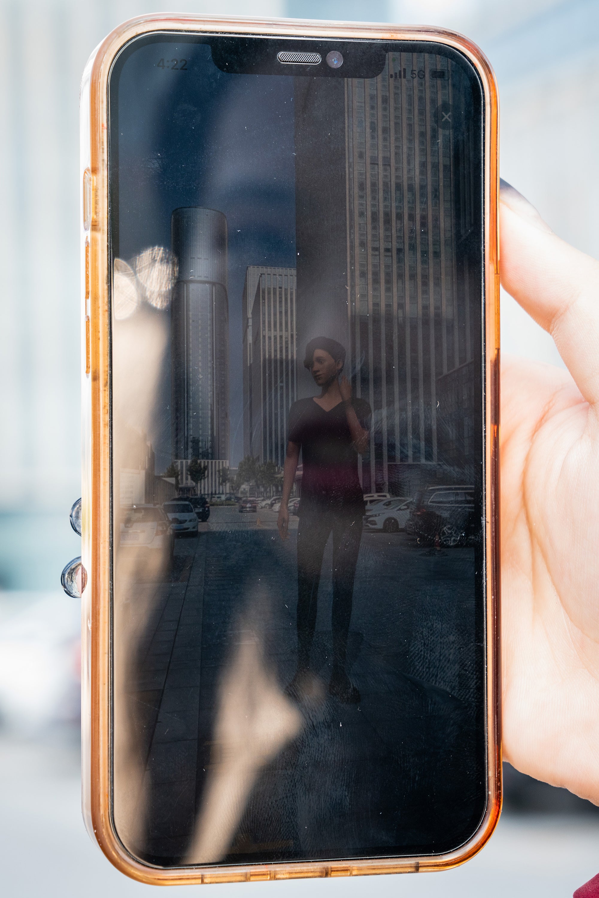 Milly Zhang is reflected on her phone’s screen as she interacts with her AI boyfriend, Qimat