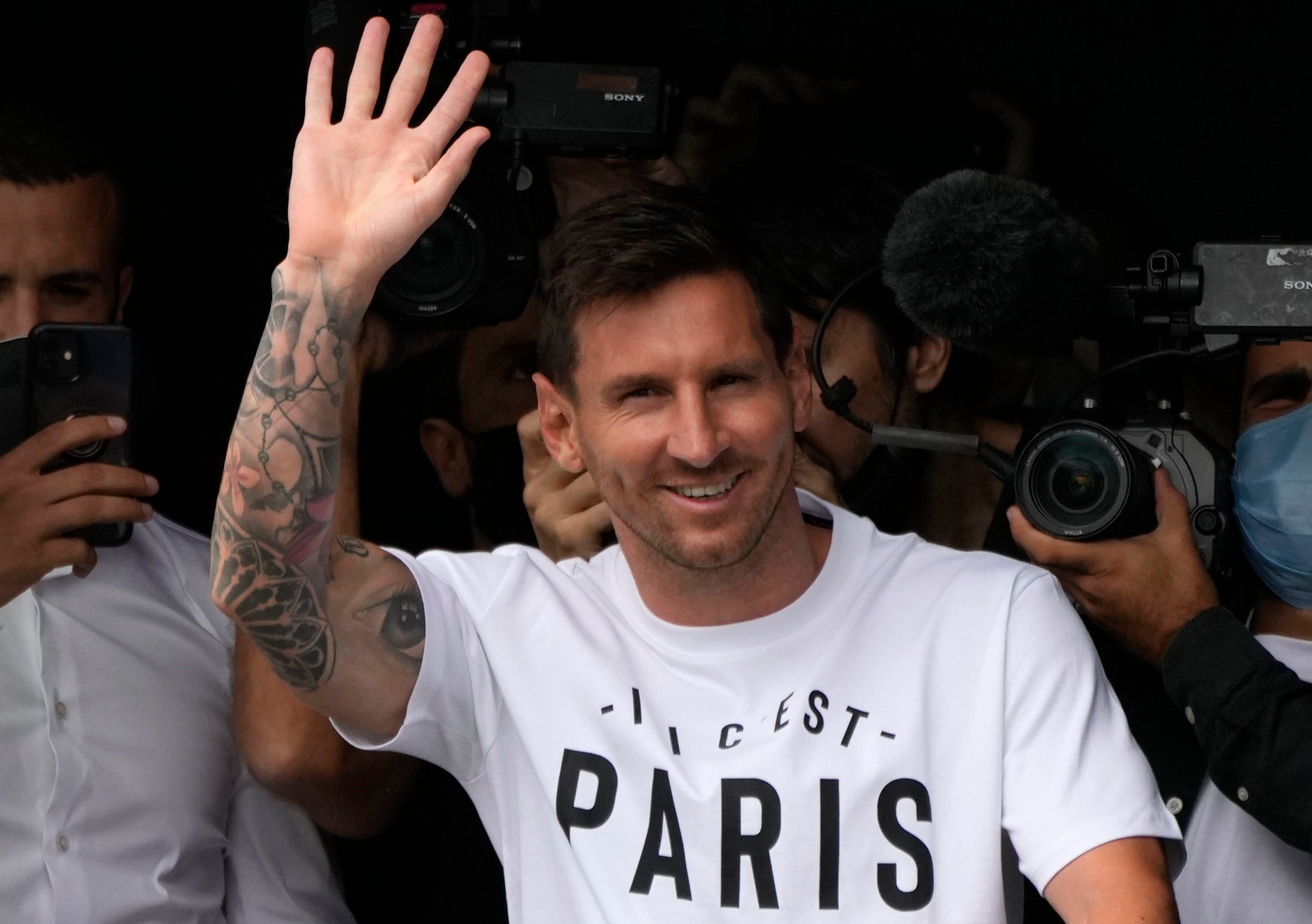 Lionel Messi, pictured waving after arriving at Le Bourget airport, north of Paris, has completed his move to Paris St Germain (Francois Mori/AP).