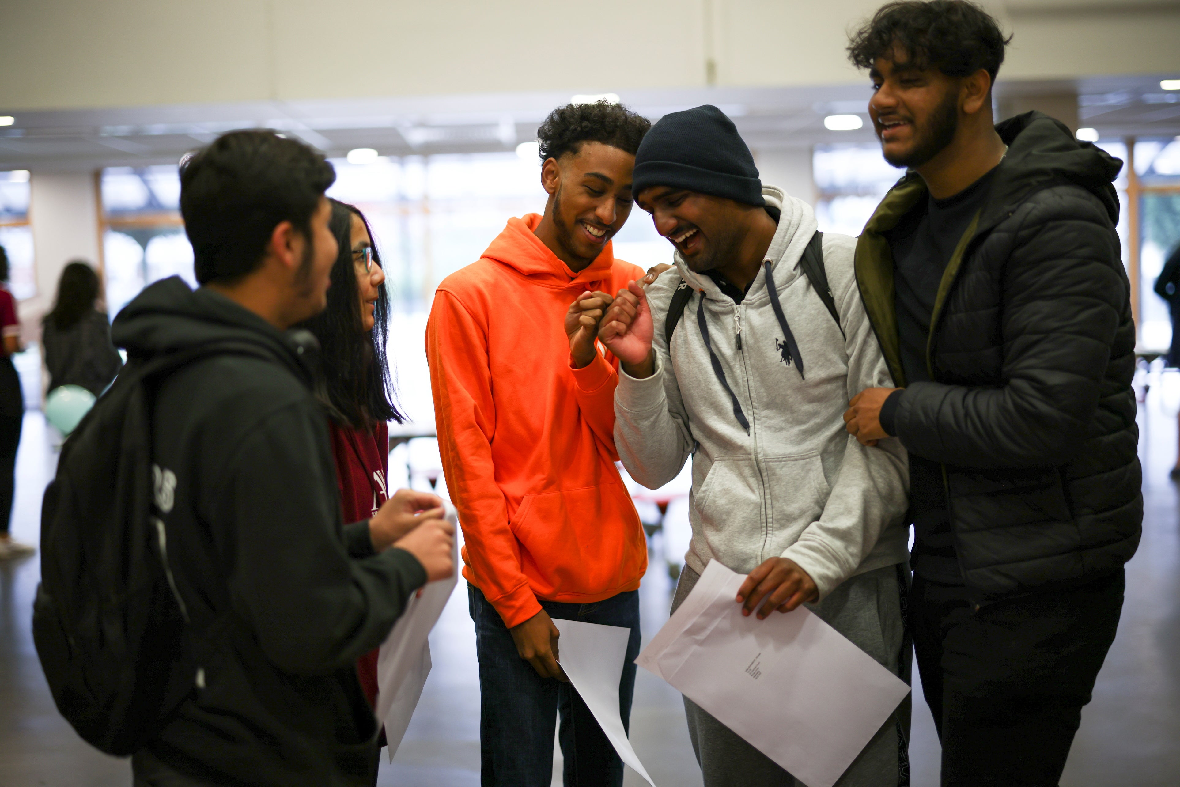 Students react after they receive their A-Level results at the Ark Academy, in London on Tuesday