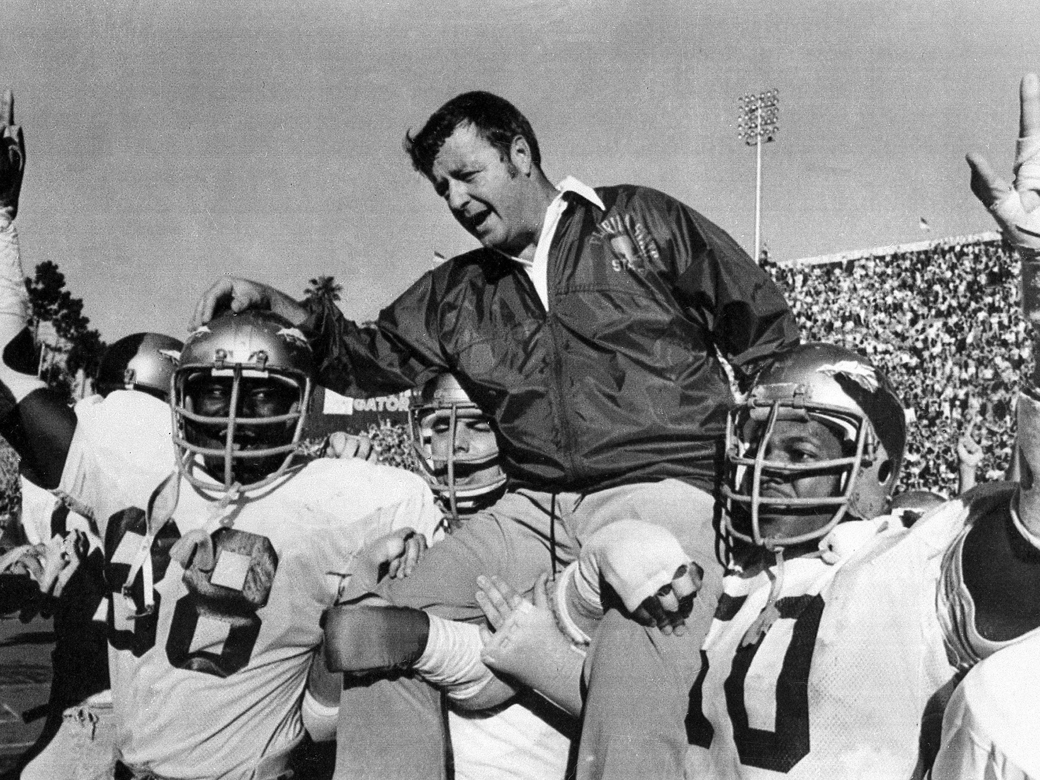 Bowden is carried on the shoulders of defensive end Willie Jones (left) and nose guard Ron Simmons (right) after winning a Florida State game in 1977