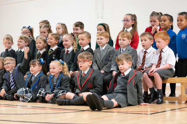 <p>Thirteen sets of twins due to start the new school term in the Inverclyde area pose for a photograph at St Mary's Primary School in Greenock</p>