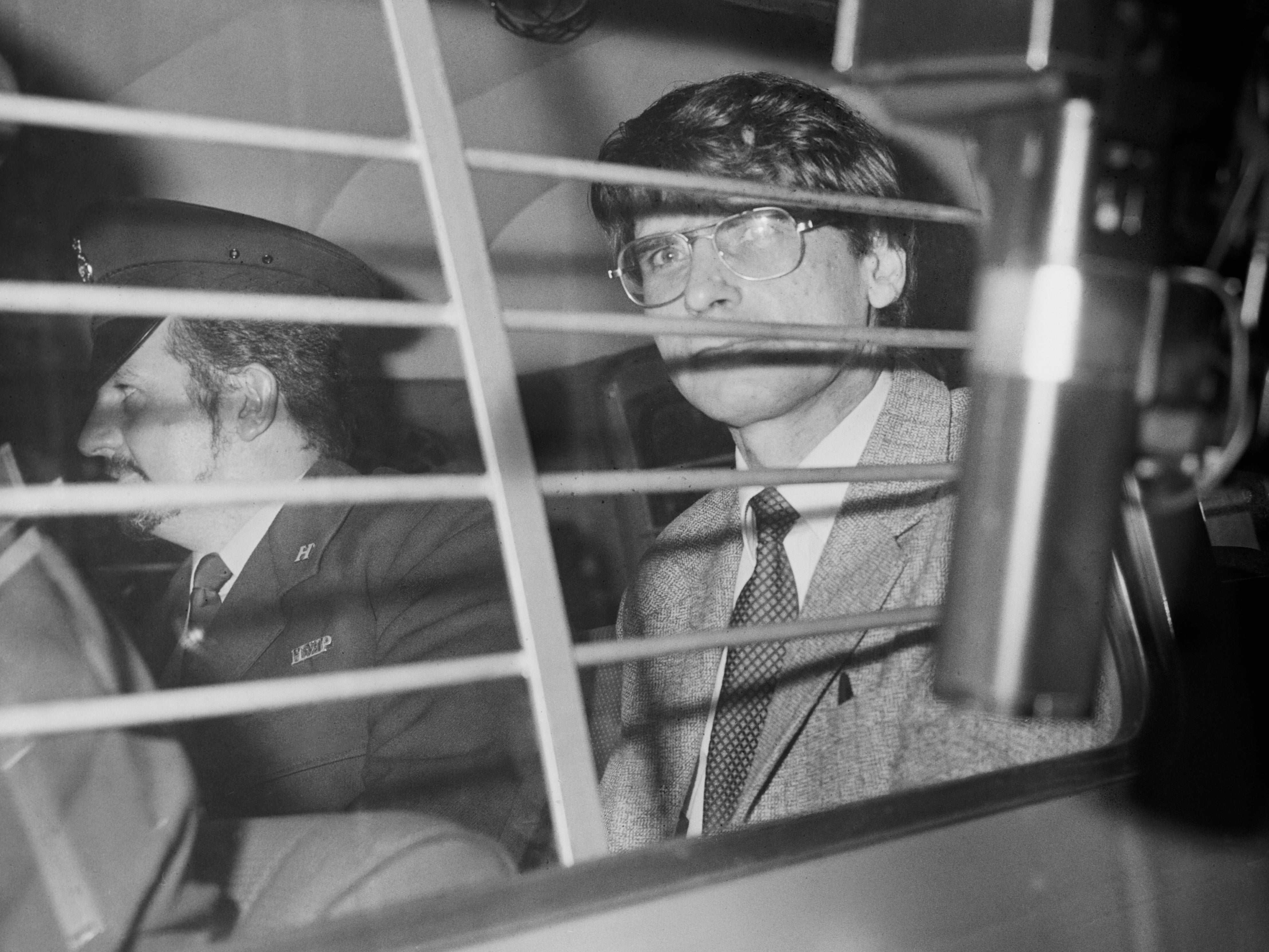 <p>Dennis Nilsen (right) is escorted in a police vehicle on 5 November 1983</p>