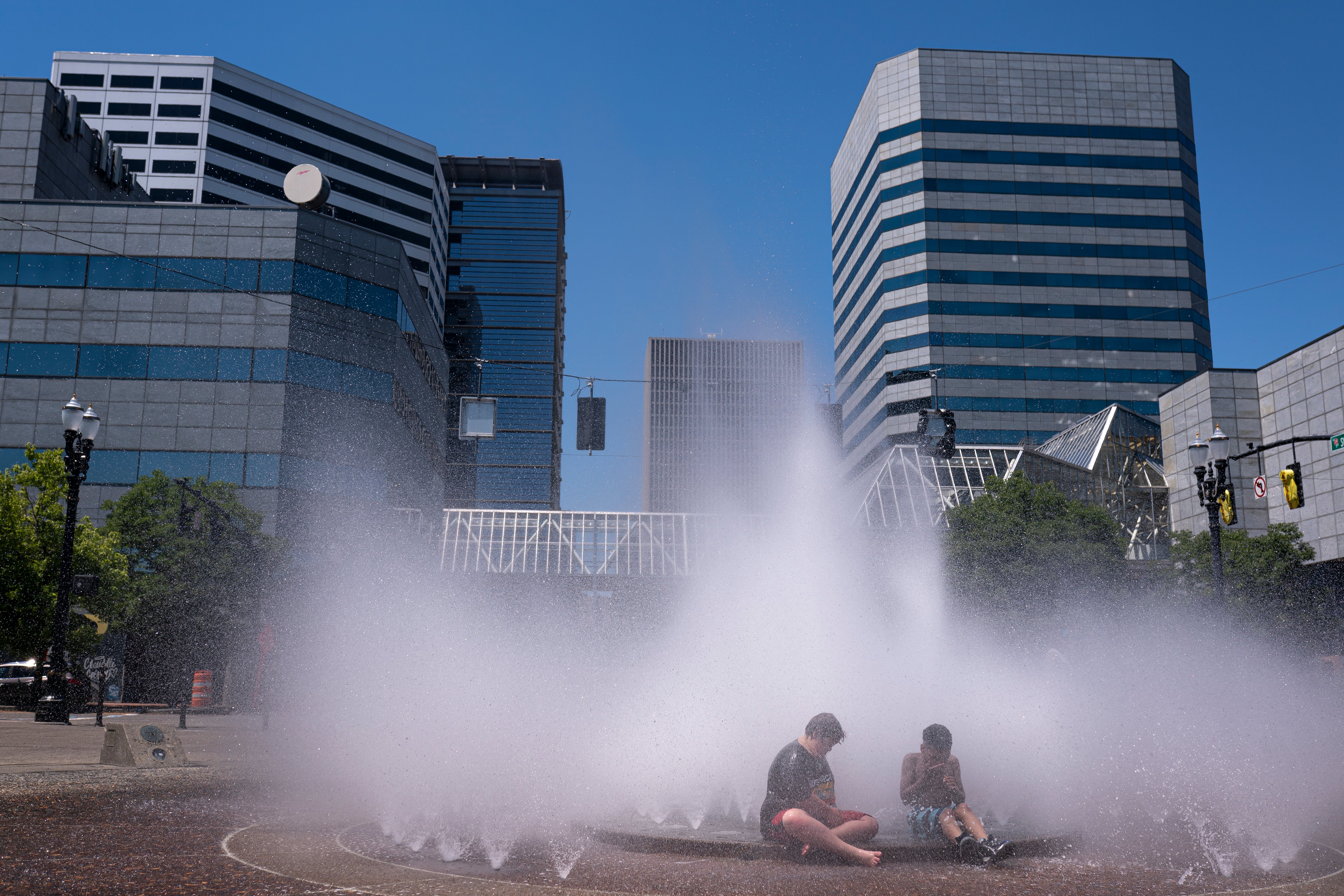 Kids play in the Salmon Springs Fountain on June 27, 2021 in Portland, Oregon. Record breaking temperatures lingered over the Northwest during a historic heatwave this weekend.