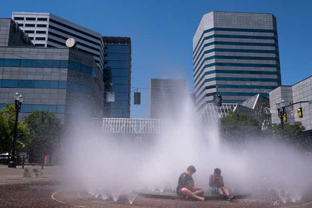 <p>Kids play in the Salmon Springs Fountain on June 27, 2021 in Portland, Oregon. Record breaking temperatures lingered over the Northwest during a historic heatwave this weekend.</p>