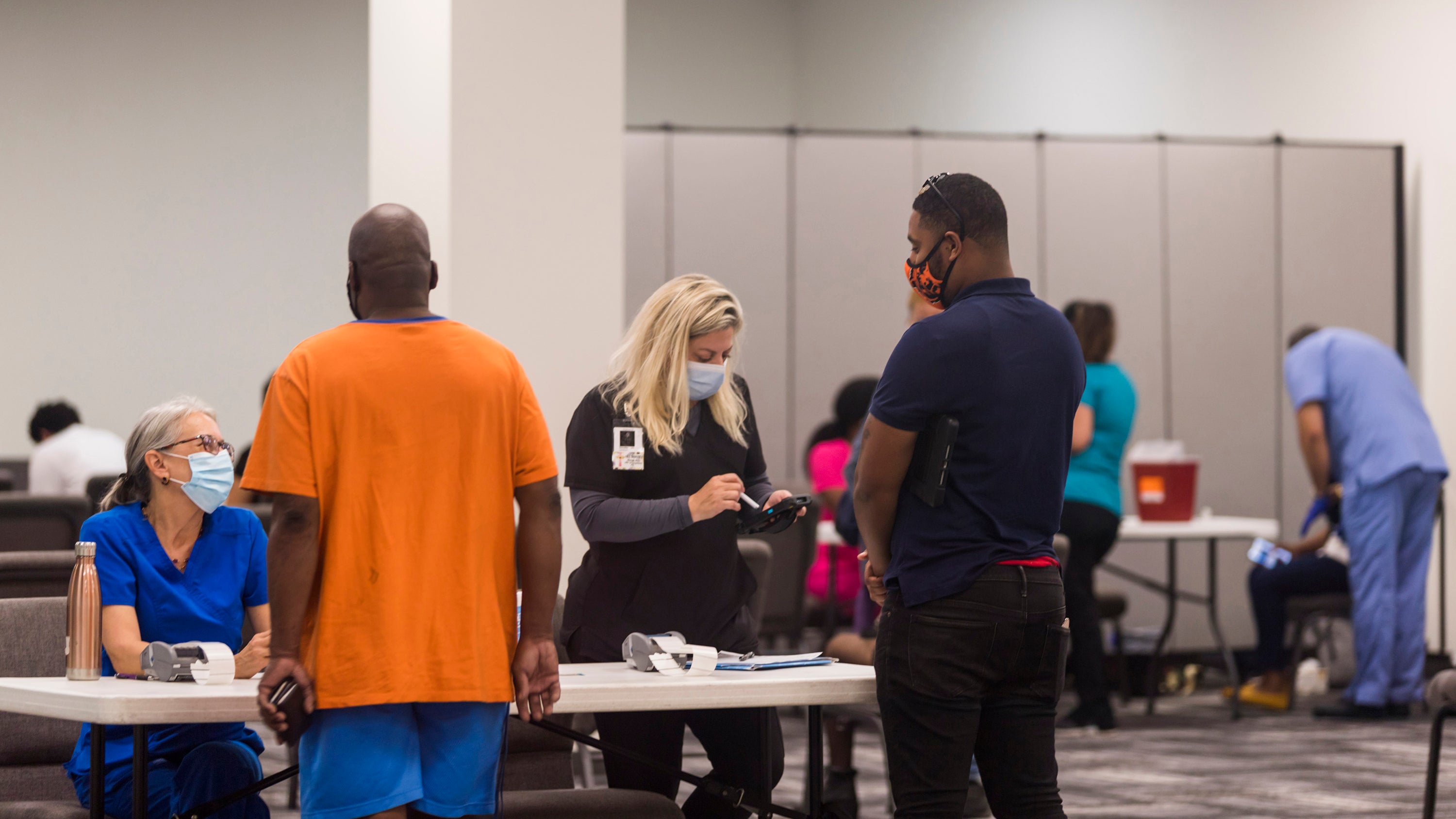 In this photo provided by Impact Church, people register for a COVID-19 vaccination at an event held by Impact Church on Aug. 8, 2021, in Jacksonville, Fla. The church has lost seven members in the last few weeks, Pastor George Davis said Wednesday, Aug. 11.