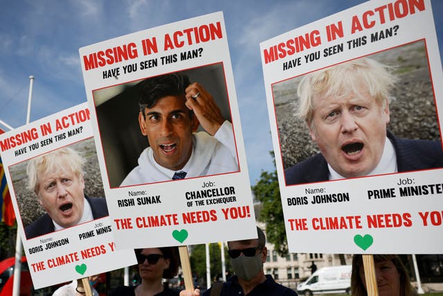 <p>This photo from 23 July shows climate change protestors demonstrating on Parliament square to mark 100 days until Cop26</p>