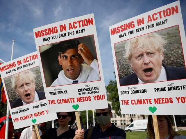 <p>Climate change protestors demonstrating in Parliament Square to mark 100 days until Cop26 on 23 July 2021 </p>