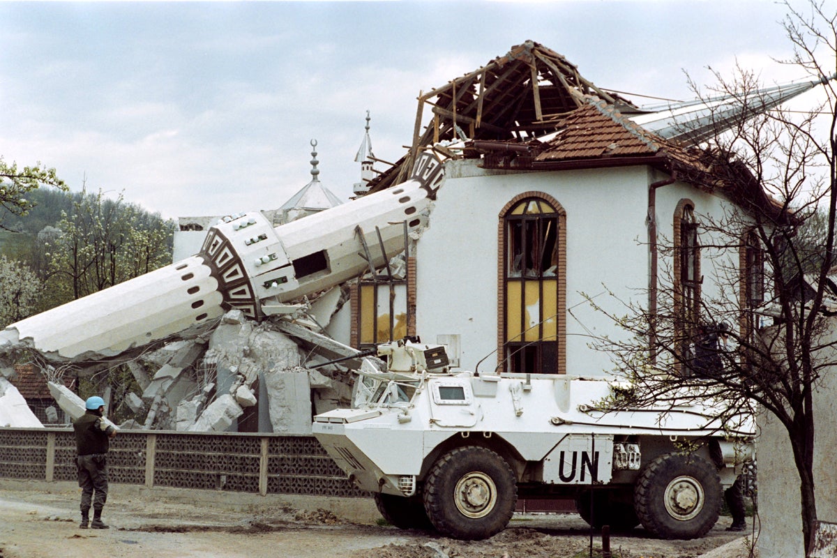 UN French troops patrol in front of the destroyed mosque of Ahinici, near Vitez, northwest of Sarajevo, 27 April 1993