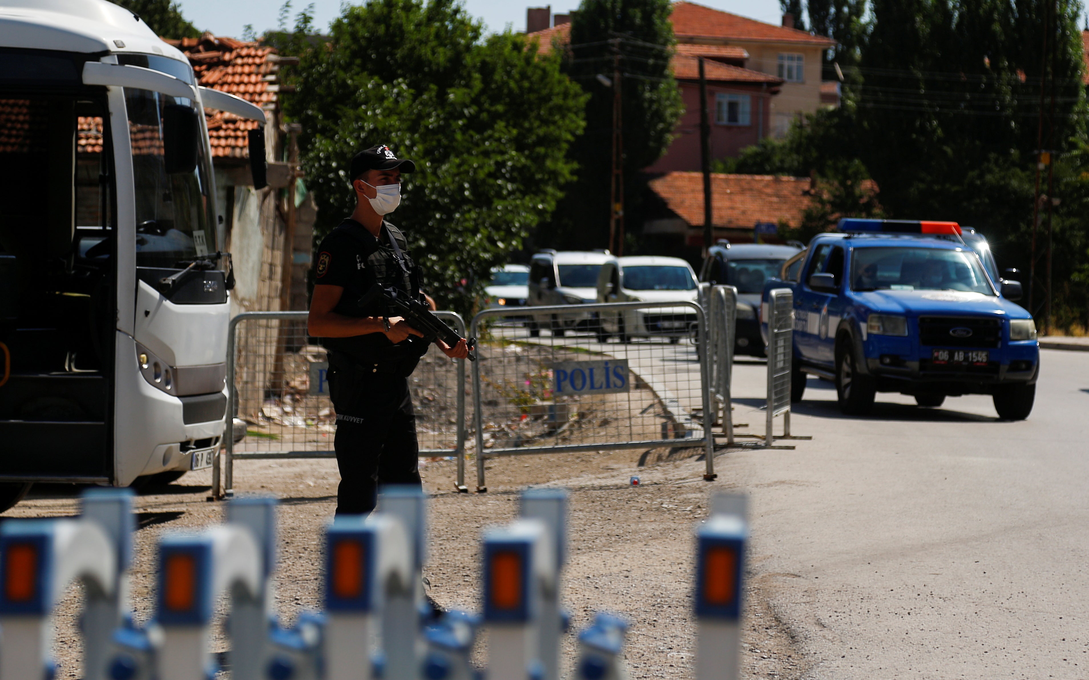 A Turkish riot police member stands guard at a check point on a road which leads to a neighbourhood where many Syrian refugees have houses and shops