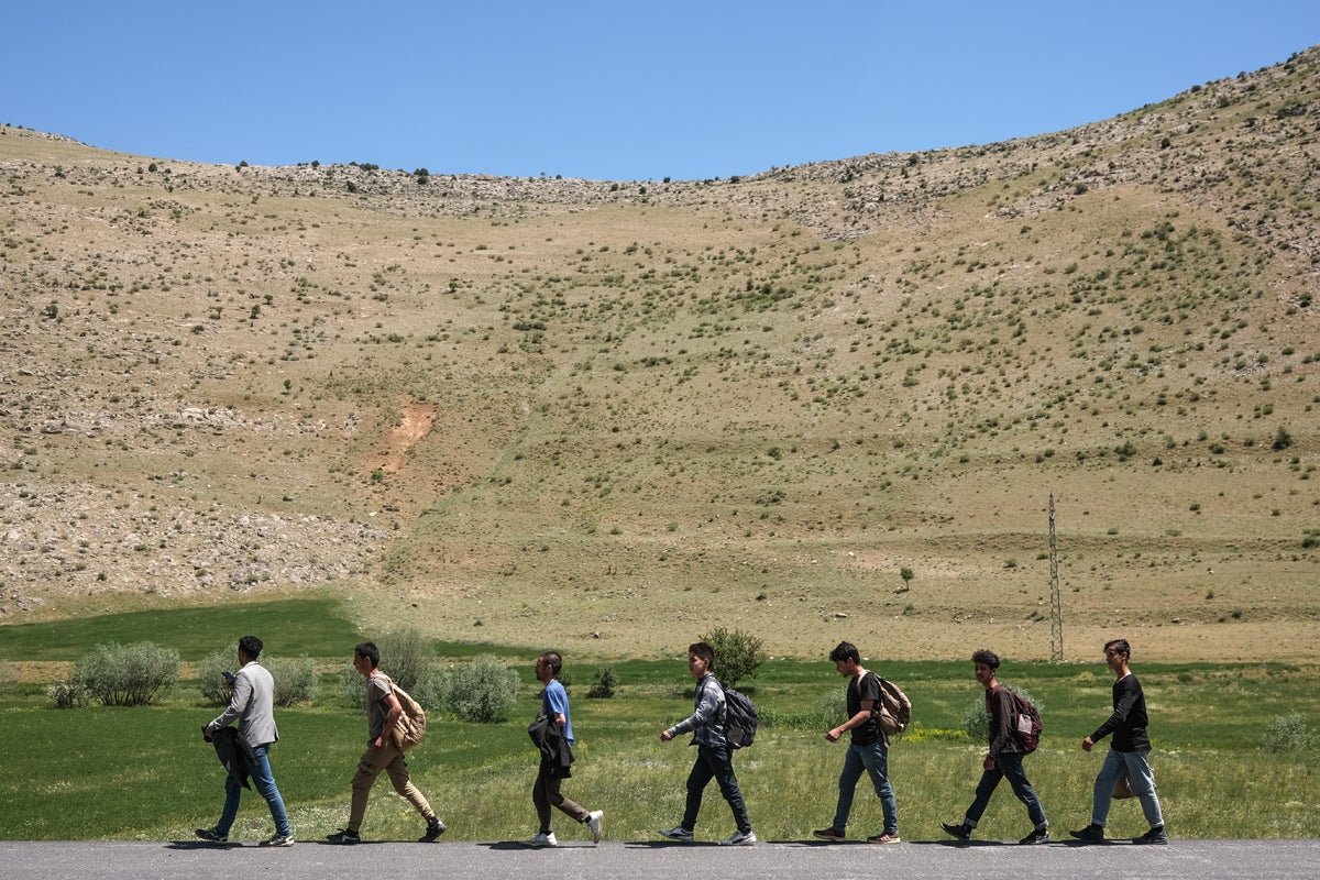 Ahmed (third from right) and his friends walk on a highway