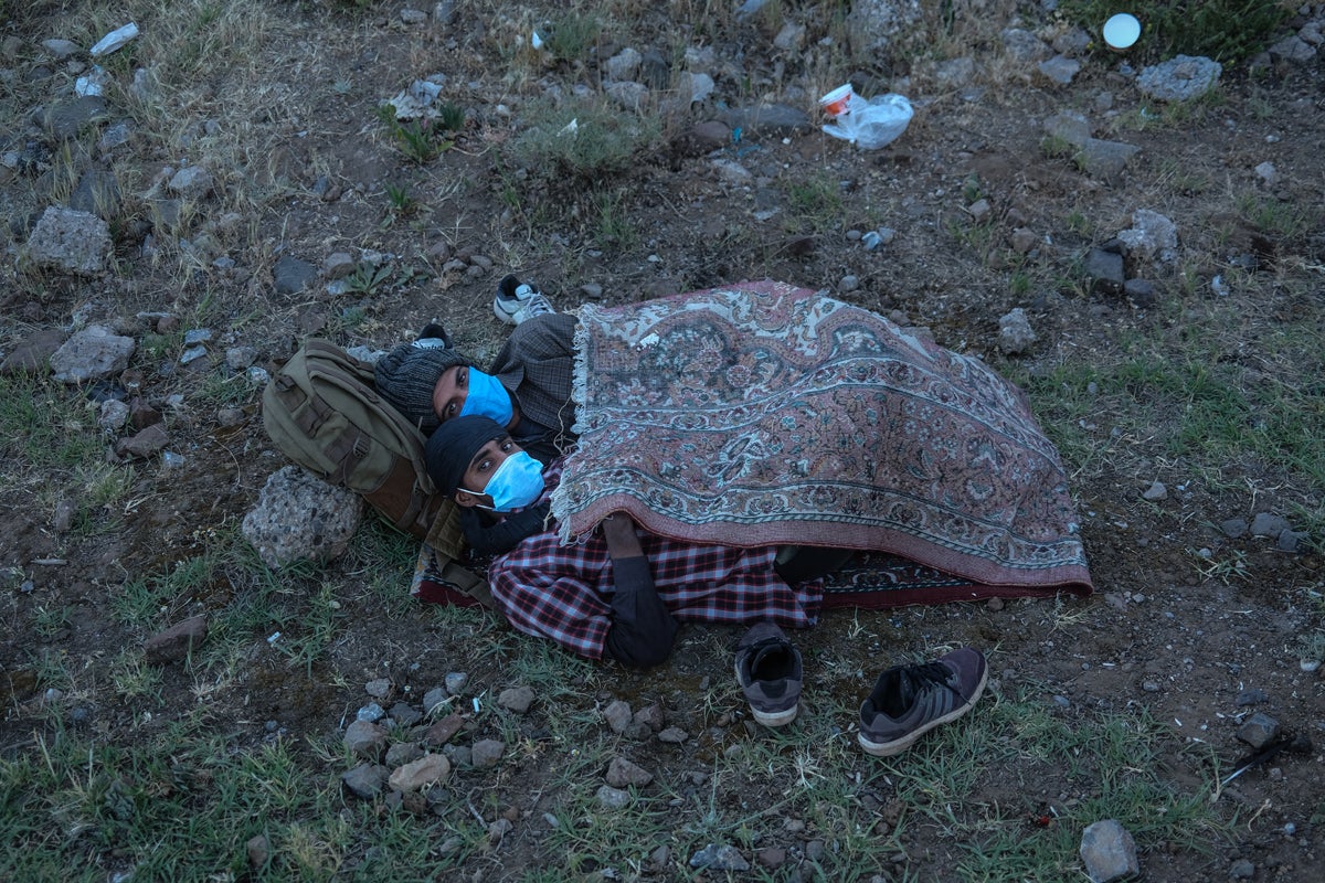 Migrants rest after a gruelling day on their feet