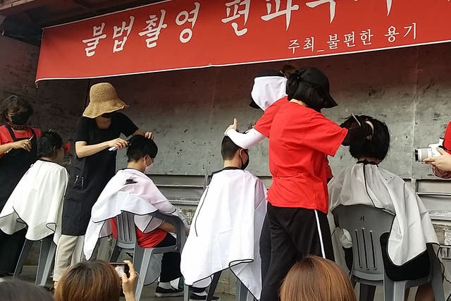 <p>South Korean women having their heads shaved during a protest against secretly-filmed spycam pornography in Seoul</p>
