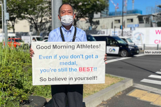 <p>A mystery man held up motivational signs for the Olympic athletes</p>