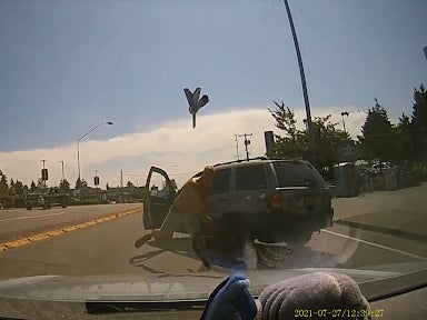 Video footage of the incident on 27 July shows a man wearing no shirt and a pair of shorts getting out of his car before hurtling an axe at someone’s windshield