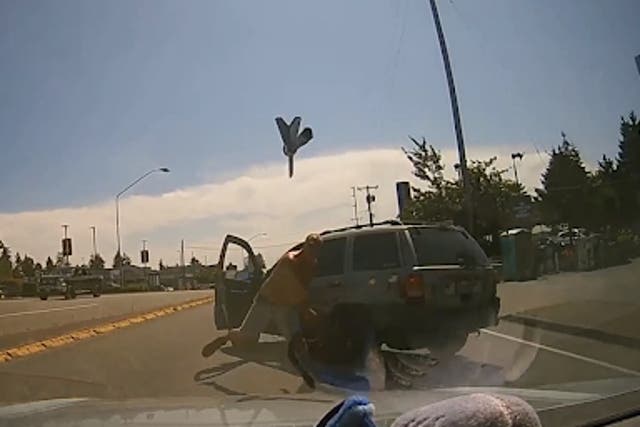<p>Video footage of the incident on 27 July shows a man wearing no shirt and a pair of shorts getting out of his car before hurtling an axe at someone’s windshield</p>