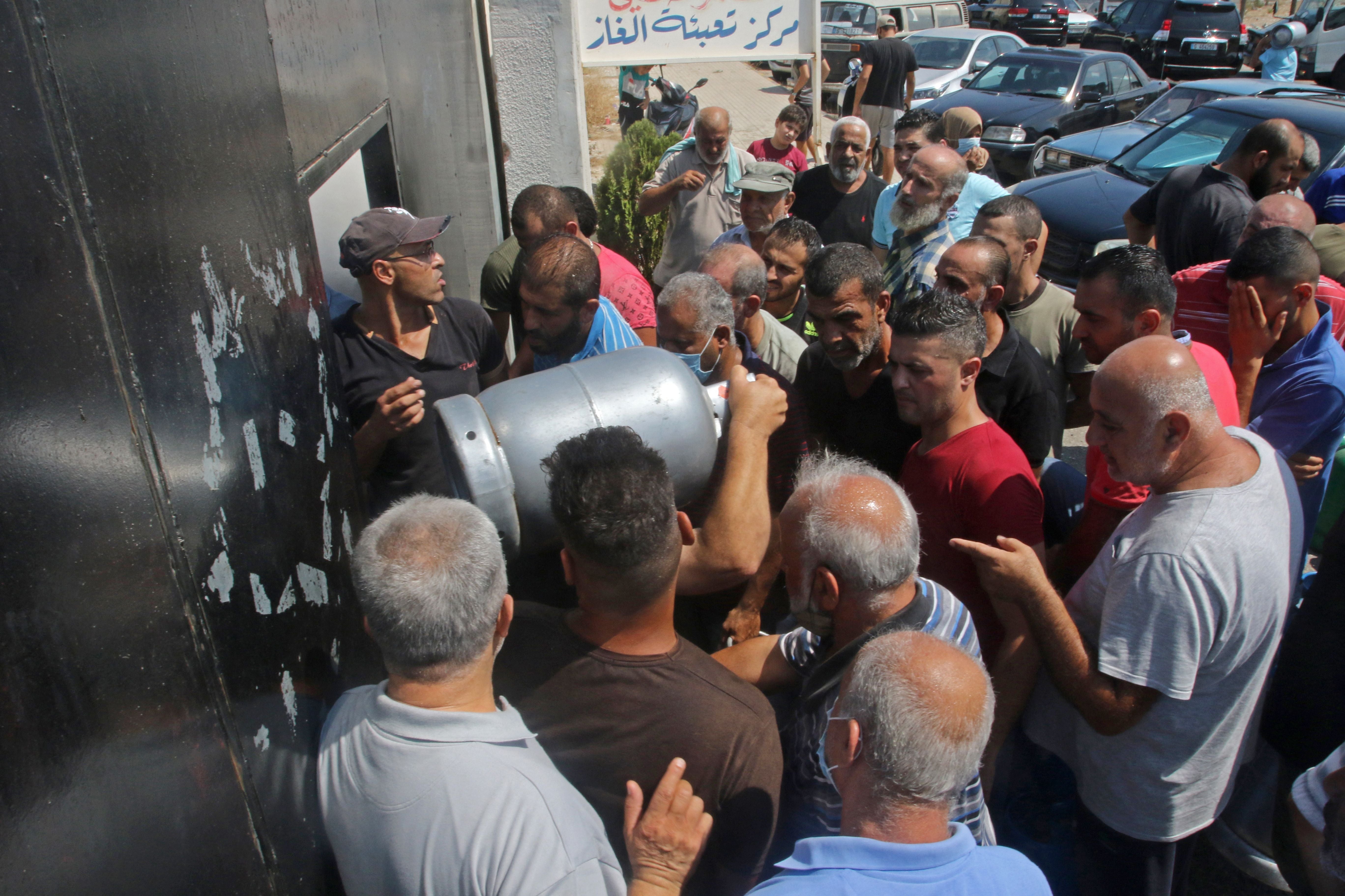 Lebanese wait to fill their gas cylinders in the southern city of Sidon amidst a deepening economic crisis