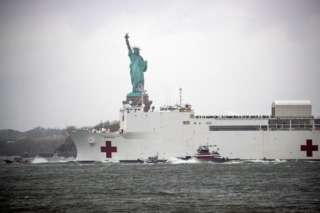 <p>The USNS Comfort hospital ship exits the harbor in front of the Statue of Liberty as it heads back to Naval Station Norfolk in Virginia on April 30, 2020 in the Red Hook neighborhood of the Brooklyn borough of New York City.</p>