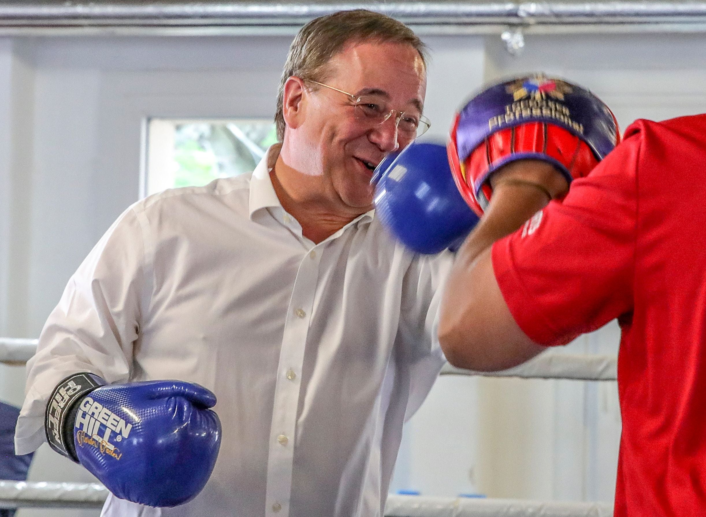 Christian Democratic Union (CDU) leader and candidate for chancellor Armin Laschet boxes with a trainer during his visit to a children's and youth's boxing camp