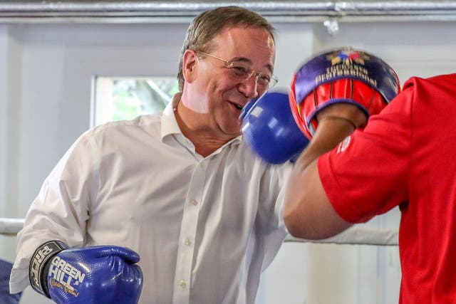 <p>Christian Democratic Union (CDU) leader and candidate for chancellor Armin Laschet boxes with a trainer during his visit to a children's and youth's boxing camp</p>