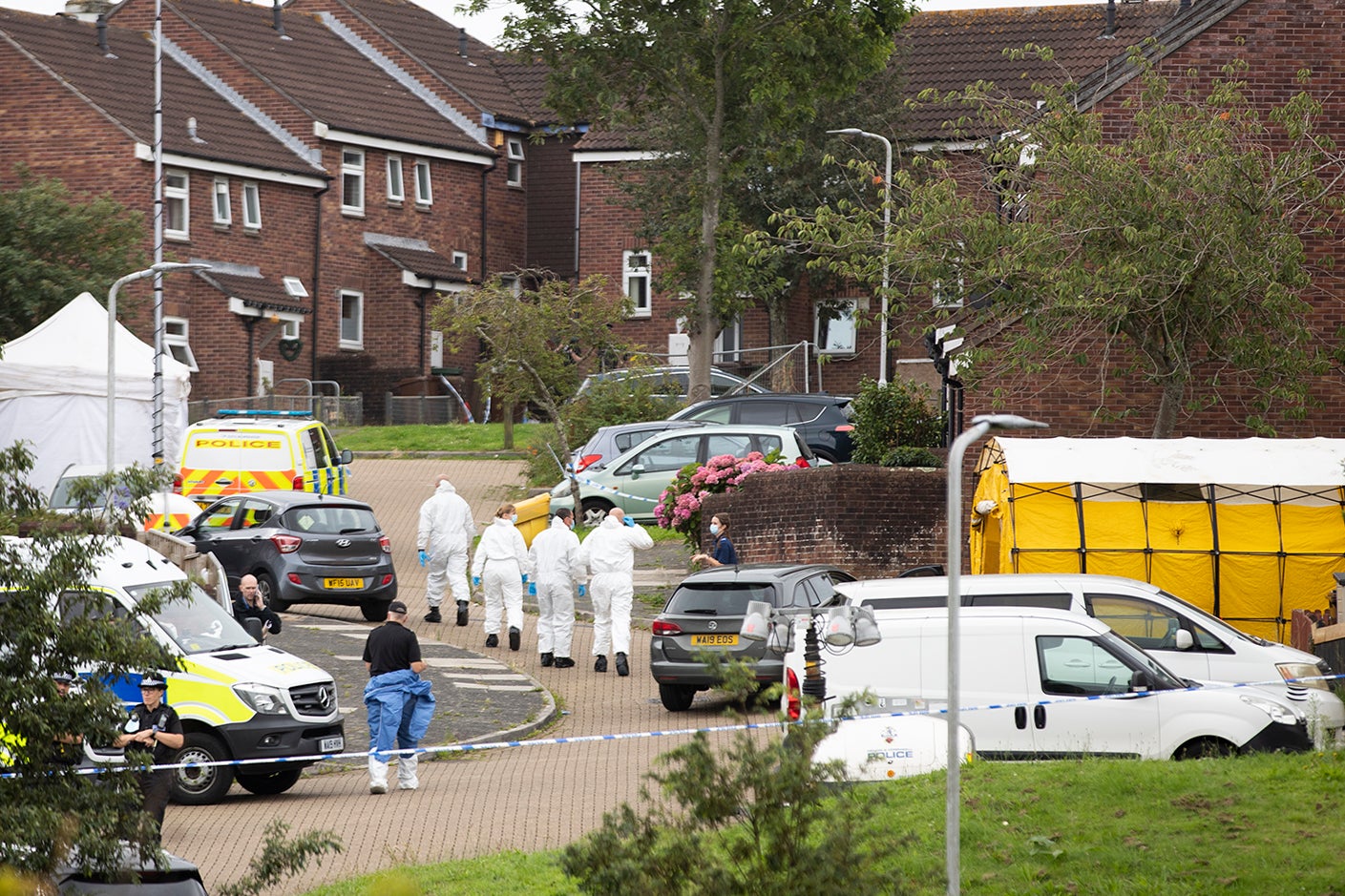 Police teams work near the scene on Biddick Drive following a shooting in Keyham, Plymouth yesterday evening