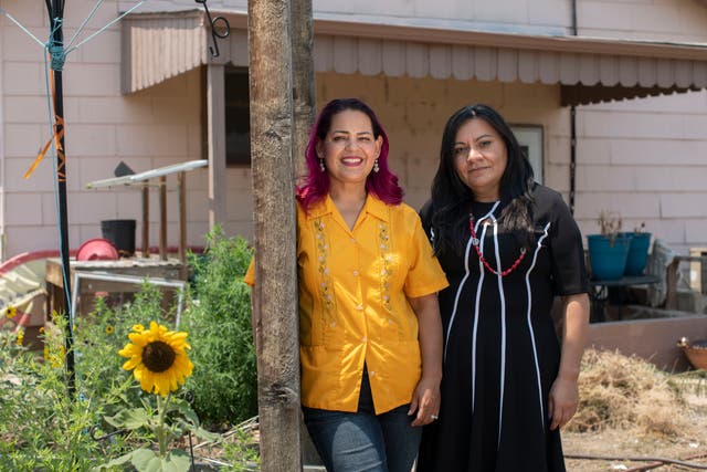 <p>From left, Maria Gonzalez, president and CEO of Adelante Community Development, and Maria Zubia, director of community outreach at Kids First Health Care, pose at the community garden behind Adelante in Commerce City, Colo., on July 15</p>