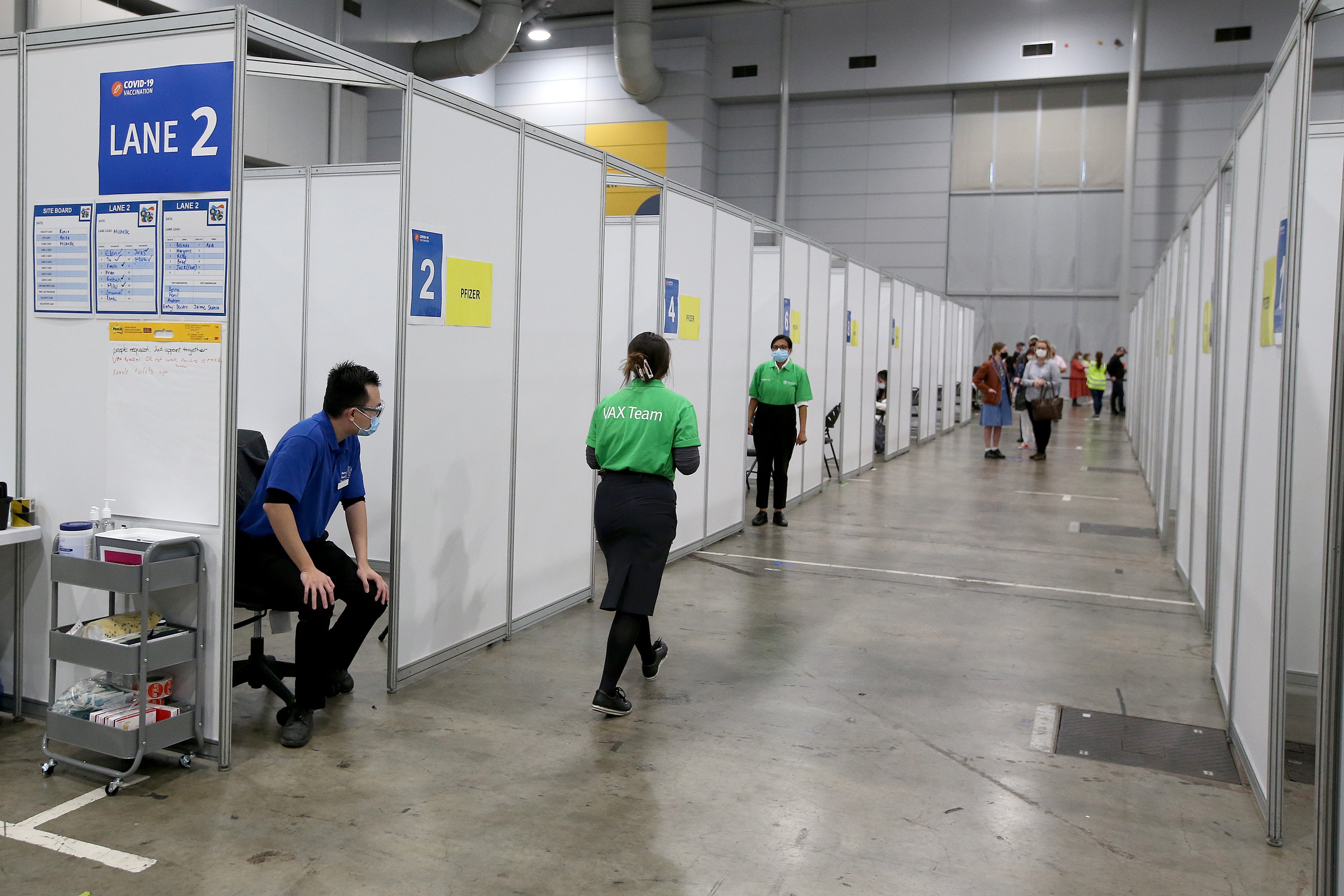 Staff work at a vaccination hub at Brisbane Convention and Exhibition Centre